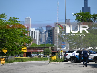 The road is being closed to the highway as Chicago police are investigating the shooting. Evidence markers are being placed on the ground to...