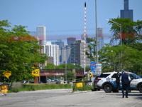 The road is being closed to the highway as Chicago police are investigating the shooting. Evidence markers are being placed on the ground to...