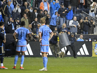 Attempts are being made to capture a pitch-invading raccoon with a garbage can, causing a five-minute delay during the first half of the Phi...