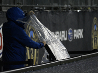 A video assistant referee (VAR) monitor on the sideline is being covered to protect it from inclement weather during the Philadelphia Union...