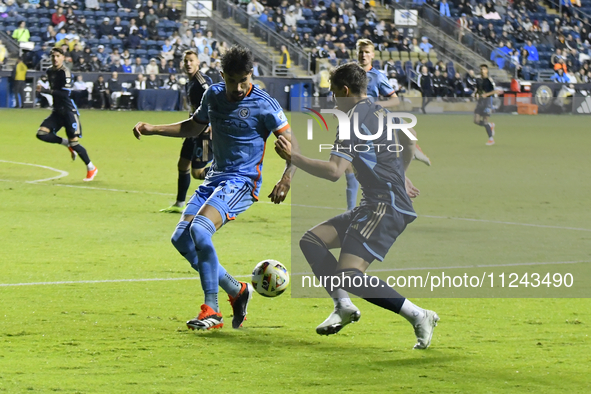 NYC FC's Defender Thiago Martins and Philadelphia Union's Forward Michael Uhre are in action during the second half of the Philadelphia Unio...