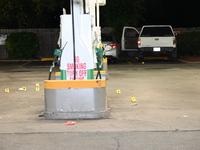 Evidence markers are being placed on the ground where shell casings are being discovered at the crime scene where a 35-year-old male is bein...