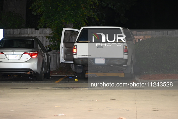 Evidence markers are being placed on the ground where shell casings are being discovered at the crime scene where a 35-year-old male is bein...