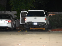 Evidence markers are being placed on the ground where shell casings are being discovered at the crime scene where a 35-year-old male is bein...