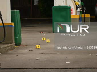 Evidence markers are being placed on the ground where shell casings are being discovered at the crime scene where a 35-year-old male is bein...