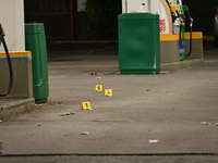 Evidence markers are being placed on the ground where shell casings are being discovered at the crime scene where a 35-year-old male is bein...