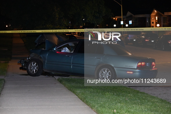 A Chicago police officer is looking over a vehicle involved in the crime scene. A 38-year-old male victim is being shot multiple times while...