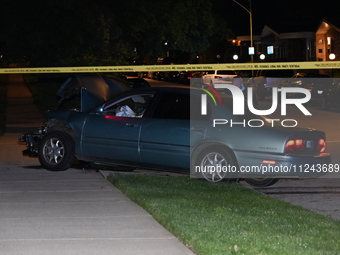 A Chicago police officer is looking over a vehicle involved in the crime scene. A 38-year-old male victim is being shot multiple times while...