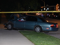 A Chicago police officer is looking over a vehicle involved in the crime scene. A 38-year-old male victim is being shot multiple times while...