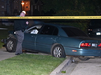 A Chicago police officer is looking over a vehicle involved in the crime scene. A 38-year-old male victim is being shot multiple times while...