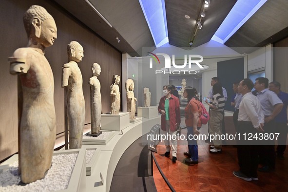 Visitors are looking at a cultural relics exhibition at Qingzhou Museum in East China's Shandong province, on May 16, 2024. 