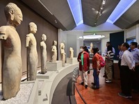 Visitors are looking at a cultural relics exhibition at Qingzhou Museum in East China's Shandong province, on May 16, 2024. (