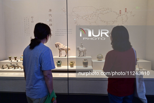 Visitors are looking at a cultural relics exhibition at Qingzhou Museum in East China's Shandong province, on May 16, 2024. 