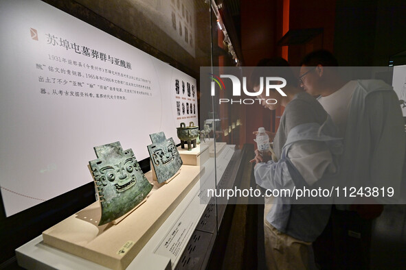 Visitors are looking at a cultural relics exhibition at Qingzhou Museum in East China's Shandong province, on May 16, 2024. 