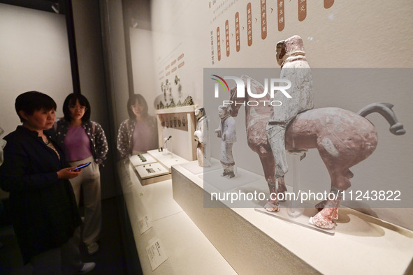 Visitors are looking at a cultural relics exhibition at Qingzhou Museum in East China's Shandong province, on May 16, 2024. 