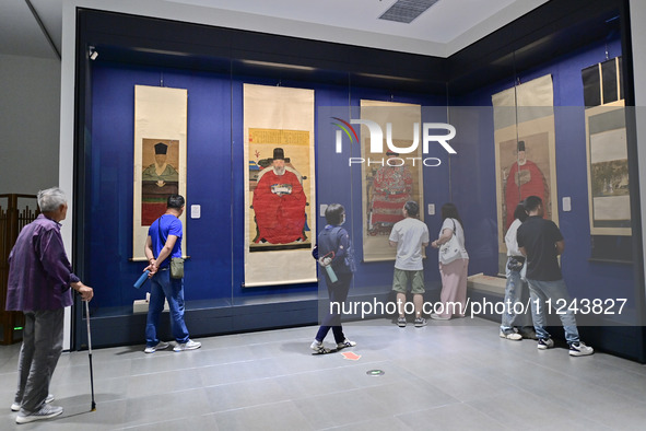 Visitors are looking at a cultural relics exhibition at Qingzhou Museum in East China's Shandong province, on May 16, 2024. 