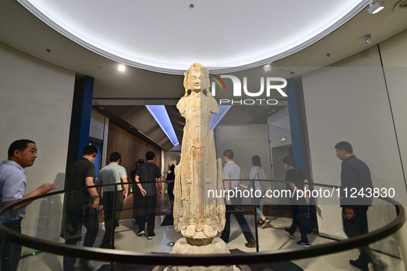 Visitors are looking at a cultural relics exhibition at Qingzhou Museum in East China's Shandong province, on May 16, 2024. 