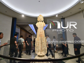 Visitors are looking at a cultural relics exhibition at Qingzhou Museum in East China's Shandong province, on May 16, 2024. (