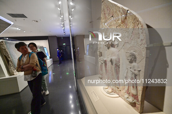 Visitors are looking at a cultural relics exhibition at Qingzhou Museum in East China's Shandong province, on May 16, 2024. 