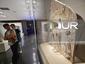 Visitors are looking at a cultural relics exhibition at Qingzhou Museum in East China's Shandong province, on May 16, 2024. (