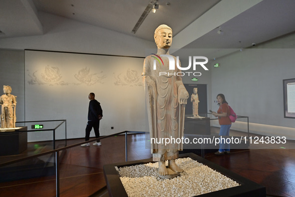 Visitors are looking at a cultural relics exhibition at Qingzhou Museum in East China's Shandong province, on May 16, 2024. 