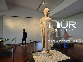 Visitors are looking at a cultural relics exhibition at Qingzhou Museum in East China's Shandong province, on May 16, 2024. (