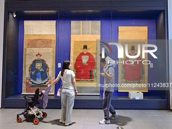 Visitors are looking at a cultural relics exhibition at Qingzhou Museum in East China's Shandong province, on May 16, 2024. (