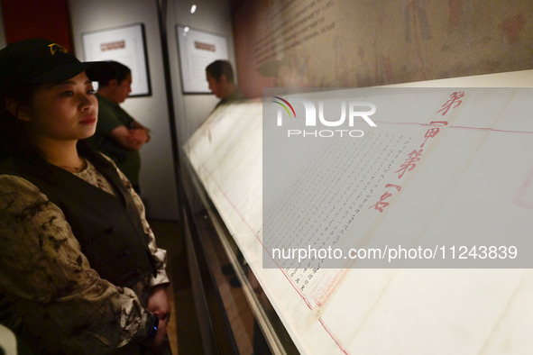 Visitors are looking at a cultural relics exhibition at Qingzhou Museum in East China's Shandong province, on May 16, 2024. 