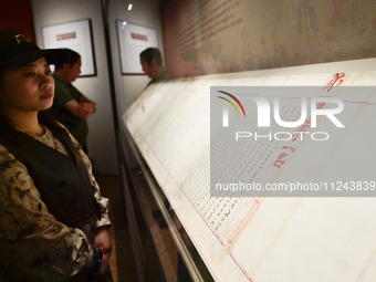 Visitors are looking at a cultural relics exhibition at Qingzhou Museum in East China's Shandong province, on May 16, 2024. (