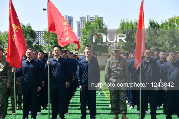 Militiamen are gathering at a checkpoint in Linyi, China, on May 16, 2024. 