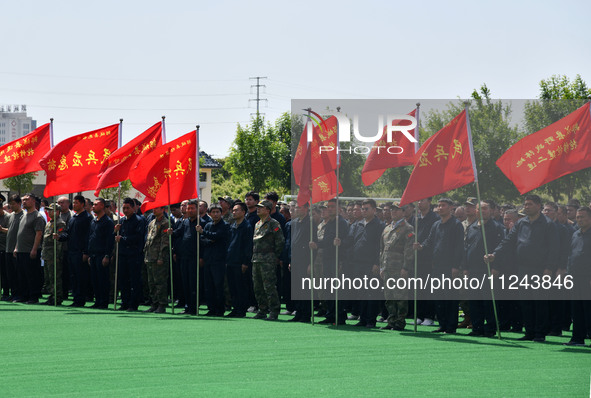 Militiamen are gathering at a checkpoint in Linyi, China, on May 16, 2024. 