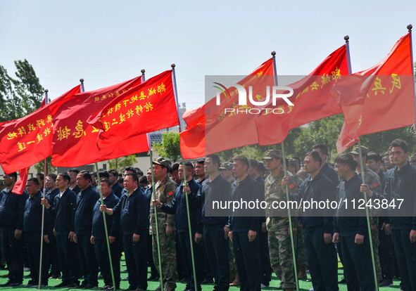 Militiamen are gathering at a checkpoint in Linyi, China, on May 16, 2024. 