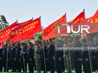 Militiamen are gathering at a checkpoint in Linyi, China, on May 16, 2024. (