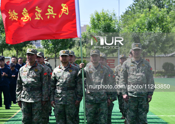 Militiamen are gathering at a checkpoint in Linyi, China, on May 16, 2024. 