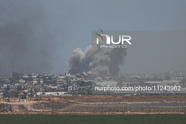 A smoke plume from an explosion is billowing in the Gaza Strip as seen from a position along Israel's southern border with the Palestinian t...