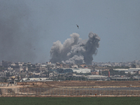 A smoke plume from an explosion is billowing in the Gaza Strip as seen from a position along Israel's southern border with the Palestinian t...