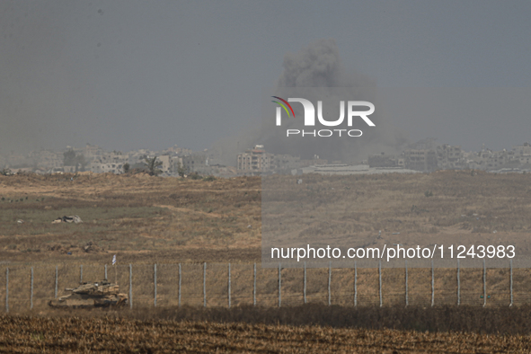 A smoke plume from an explosion is billowing in the Gaza Strip as seen from a position along Israel's southern border with the Palestinian t...