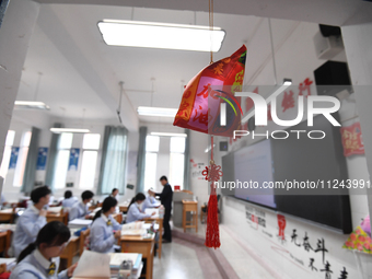 Senior three students are studying hard for the National college entrance examination in a class in Guiyang, China, on May 16, 2024. (