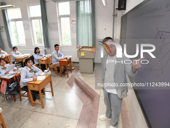 Senior three students are studying hard for the National college entrance examination in a class in Guiyang, China, on May 16, 2024. (