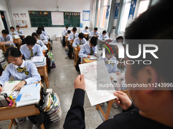 Senior three students are studying hard for the National college entrance examination in a class in Guiyang, China, on May 16, 2024. (