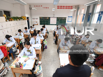 Senior three students are studying hard for the National college entrance examination in a class in Guiyang, China, on May 16, 2024. (