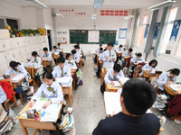 Senior three students are studying hard for the National college entrance examination in a class in Guiyang, China, on May 16, 2024. (