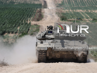 An Israeli army battle tank is moving near the border with the Gaza Strip in southern Israel on May 16, 2024, amid the ongoing conflict in t...