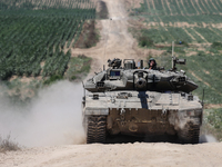 An Israeli army battle tank is moving near the border with the Gaza Strip in southern Israel on May 16, 2024, amid the ongoing conflict in t...