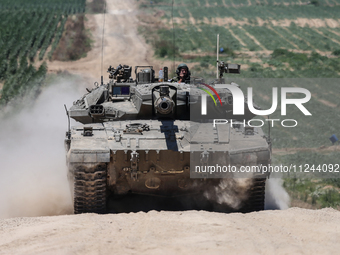 An Israeli army battle tank is moving near the border with the Gaza Strip in southern Israel on May 16, 2024, amid the ongoing conflict in t...