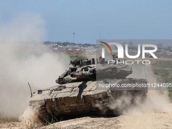 An Israeli army battle tank is moving near the border with the Gaza Strip in southern Israel on May 16, 2024, amid the ongoing conflict in t...