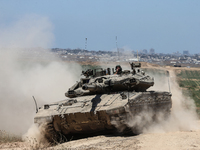 An Israeli army battle tank is moving near the border with the Gaza Strip in southern Israel on May 16, 2024, amid the ongoing conflict in t...