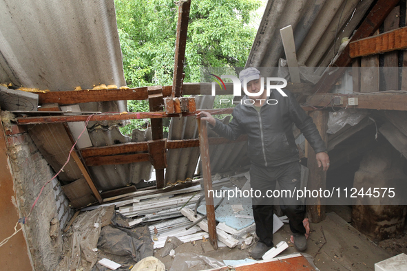 A displaced man from Avdiivka, Donetsk region, is being pictured in a house damaged by the falling debris of a Russian rocket in Dnipro, Ukr...