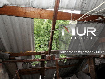 The roof of a house is being damaged by the falling debris of a Russian rocket in Dnipro, Ukraine, on May 15, 2024. NO USE RUSSIA. NO USE BE...