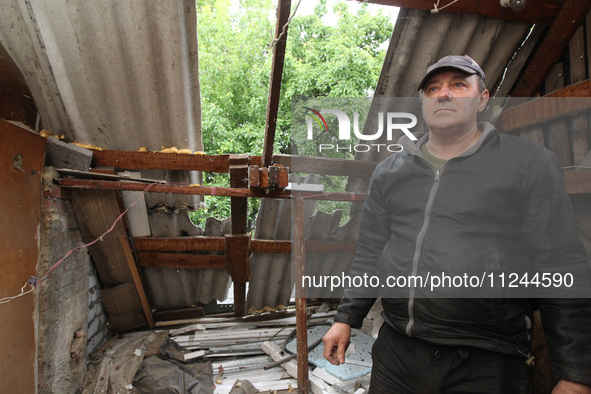 A displaced man from Avdiivka, Donetsk region, is being pictured in a house damaged by the falling debris of a Russian rocket in Dnipro, Ukr...